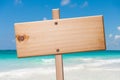 Wood sign in the beach. Royalty Free Stock Photo