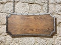 Wood sign with metal frame on old stone wall Royalty Free Stock Photo