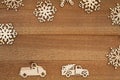 Wood snowflakes and retro trucks on weathered wood holiday background
