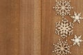 Wood snowflakes on weathered wood holiday background