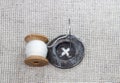 Wood spool with white thread, needle and sewn Royalty Free Stock Photo