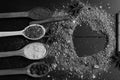 Wood spoons with paprika, turmeric, herbs and pepper by cinnamon and anise. Composition of condiment making heart shape