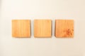 Wood square bar pieces with shadows on white background. Horizontal row of wooden squares as concept of kids development toy,