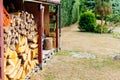 Wood stack with stacked firewood stock for fireplace heating in shed