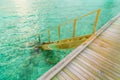 Wood stair into the sea of tropical Maldives island . Royalty Free Stock Photo