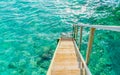 Wood stair into the sea of tropical Maldives island . Royalty Free Stock Photo