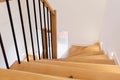 Wood staircase inside contemporary white modern house. Royalty Free Stock Photo