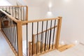 Wood staircase inside contemporary white modern house.