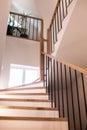 Wood staircase inside contemporary white modern house. Royalty Free Stock Photo