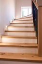 Wood staircase inside contemporary white modern house. Royalty Free Stock Photo