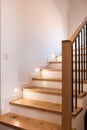 Wood staircase inside contemporary white modern house. Royalty Free Stock Photo