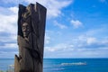 Wood Statue of an indigenous with the see behind in Punta Arenas, Chile aligned