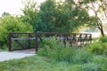 Wood and steel bridge on walking path over stream