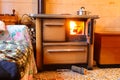 wood stove of the economical kitchen inside a mountain house with the fire lit