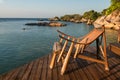 Wood sunbed deck at resort patio by sea in morning, Ko Man Klang Royalty Free Stock Photo