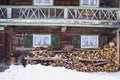 Winter, snowy stack of firewood in front of an old farm, Bavaria, Germany