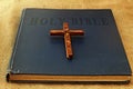 Wood Symbol of Christianity Christian Cross and Vintage Book Holy Bible in English. Concept: Christian religion and traditions Royalty Free Stock Photo