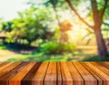 wood table and blur image of Bokeh of green tree . Royalty Free Stock Photo