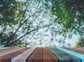 wood table and blur image of green tree bokeh. Royalty Free Stock Photo
