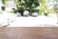 Wood table in cafe with blur parking lot background