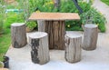 Wood table and chair set in garden. Garden furniture made from wooden log Royalty Free Stock Photo