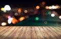 Wood table with city lights night blurred background Royalty Free Stock Photo