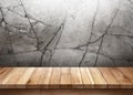 Wood table with cracked stone wall background Royalty Free Stock Photo