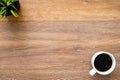 Wood table with cup of coffee and grass pot. Top view with copy space, flat lay Royalty Free Stock Photo