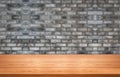 Wood table in front of brick wall blur background Royalty Free Stock Photo