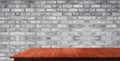 Wood table in front of brick wall blur background Royalty Free Stock Photo