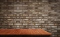 Wood table in front of brick wall blur background. Royalty Free Stock Photo