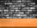 Wood table in front of brick wall blur background. Royalty Free Stock Photo