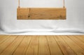 Wood table with hanging wooden sign on white fabric background Royalty Free Stock Photo