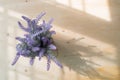 Wood table with purple lavender artificial flower on pot at liv