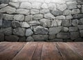 Wood table with stone wall background Royalty Free Stock Photo