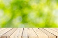 Wood table top and Abstract blur green leaves background Royalty Free Stock Photo