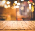 Wood table top Bar with blur light bokeh in dark night cafe,restaurant background Royalty Free Stock Photo