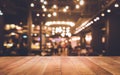 Wood table top Bar with blur light bokeh in dark night cafe Royalty Free Stock Photo