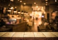 Wood table top Bar with blur light bokeh in dark night Royalty Free Stock Photo