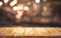 Wood table top Bar with blur light bokeh in dark night cafe,restaurant background Royalty Free Stock Photo