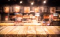 Wood table top Bar with blur light bokeh in dark night cafe,restaurant background Royalty Free Stock Photo