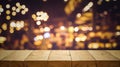 Wood table top Bar with blur light bokeh in dark night cafe Royalty Free Stock Photo