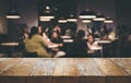 Wood table top Bar with blur people siting in cafe background Royalty Free Stock Photo