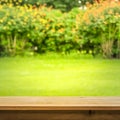 Wood table top on blur abstract green,flower from garden Royalty Free Stock Photo