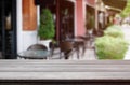 Wood table top on blur background of coffee shop (or restaurant) interior - can be used for display or montage your products Royalty Free Stock Photo