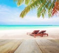 Wood table top on blur beach background with beach chairs Royalty Free Stock Photo