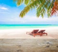 Wood table top on blur beach background with beach chairs Royalty Free Stock Photo