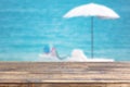 wood table top on blur beach umbrella on the sea background Royalty Free Stock Photo