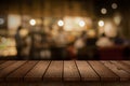 Wood table top on blur bokeh coffee shop or cafe restaurant background. Can be used for display or montage your products