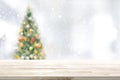 Wood table top on blur Christmas tree background Royalty Free Stock Photo
